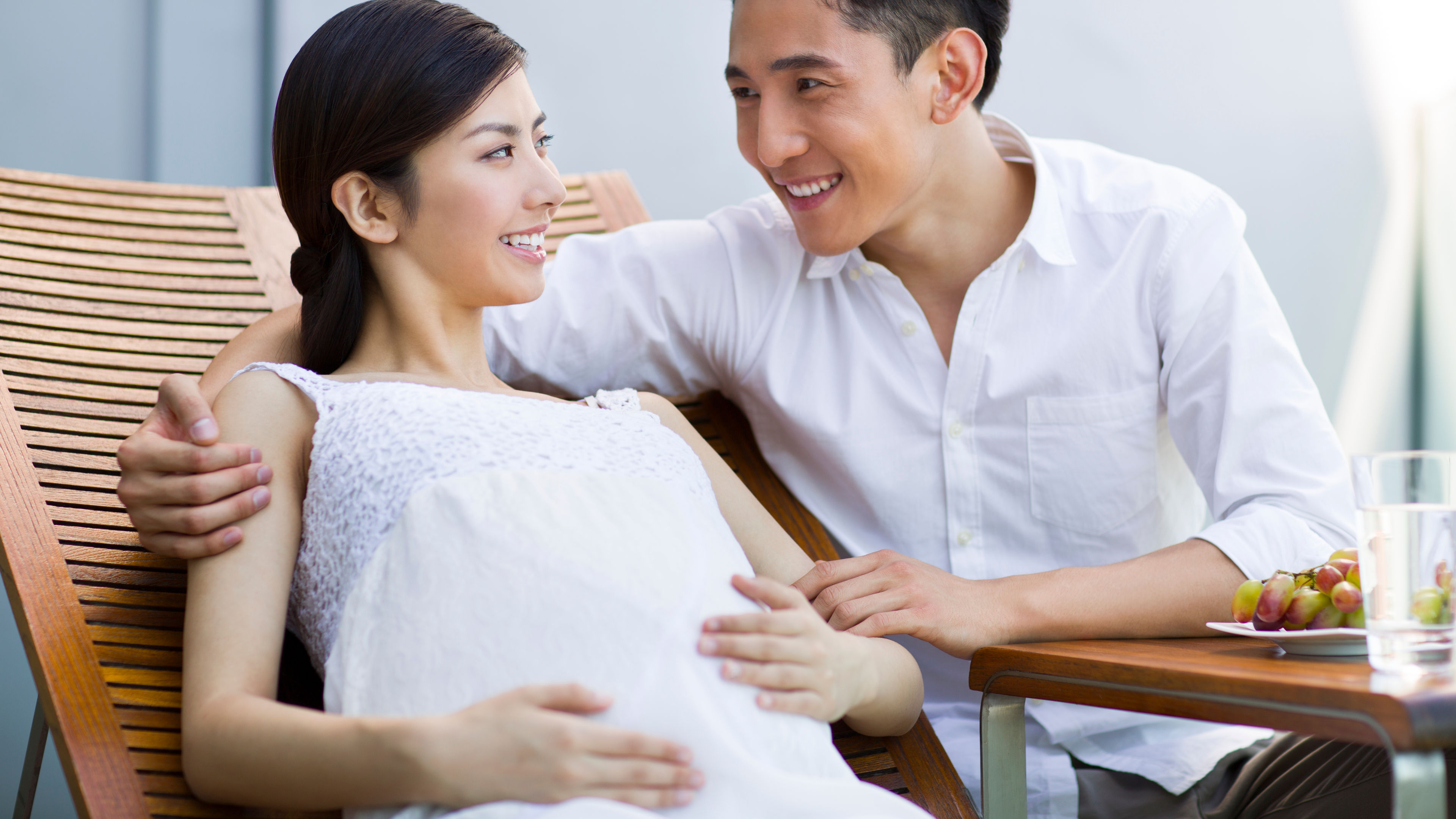 A pregnant couple relaxing